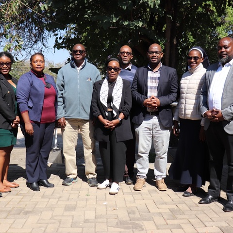 JCTR staff pose for a group photo with a delegation from Southern Africa Trust